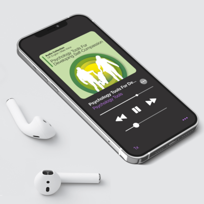 Psychology Tools For Developing Self-Compassion Audio Collection being played on an iPhone with wireless headphones.